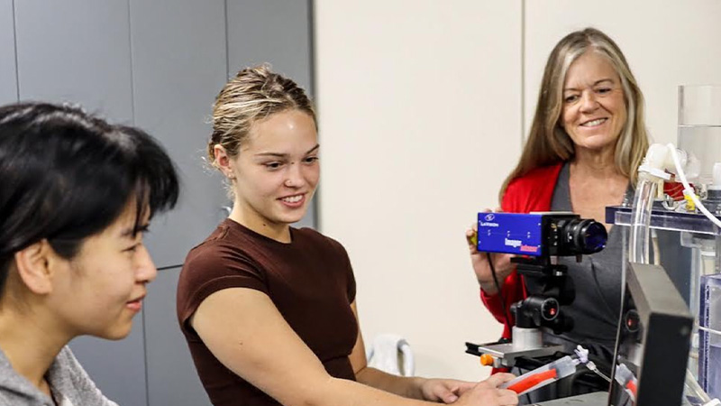 Dr. May-Newman working with her students