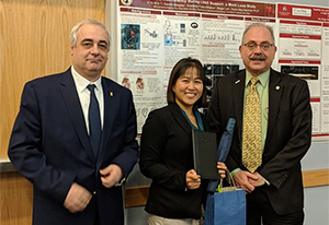 Vi Vu holding her award with those who presented it to her