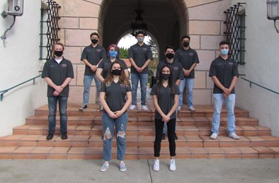 the executive board standing with masks on