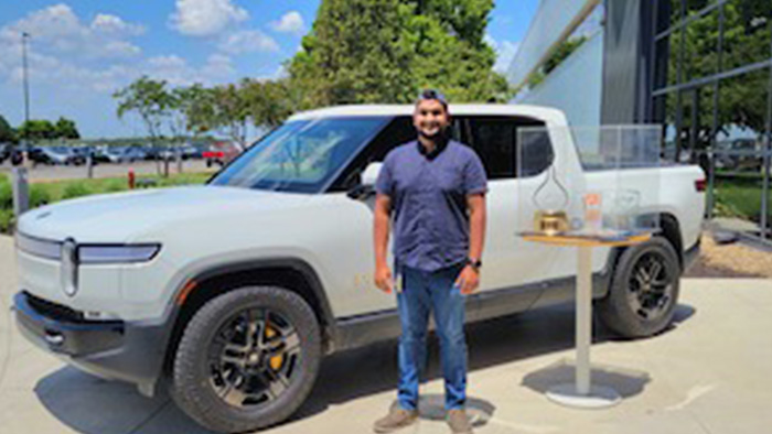 Andrew da Cuhna in front of Rivian Truck